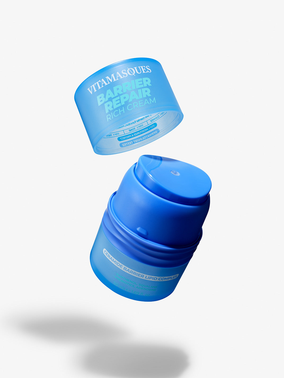 Vitamasques Barrier Repair Rich Cream with ceramide and lipid complex, designed to restore and strengthen the skin's protective barrier. Blue airless pump container with the lid open.